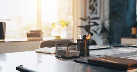 Business, interior and stationery on desk in empty office for career, occupation or profession....