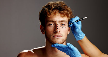 Beauty, plastic surgery and lines on face of man in studio for prp, aesthetics and collagen. Planning, skincare and dermatology with person on gray background for facial, cosmetics and fillerの写真素材