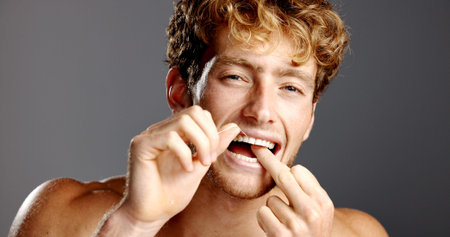 Dental health, flossing and portrait of man in studio with fresh breath, grooming or plaque removal....