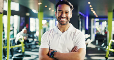 Happy, gym manager or portrait with arms crossed for facility management, wellness service or pride. About us, professional and smile at sports club for customer satisfaction or equipment maintenanceの写真素材