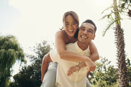 Happiness, couple and piggyback in garden for love, summer and having fun together outdoor....