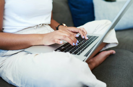 Woman, laptop and hands for remote work on couch, check email and freelancer on website in home....