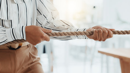 Tug of war, rope and businesswoman in office for game, opposition or challenge in career opportunity. Power, hands and female lawyer with activity for battle, fight or competition for job promotion.の写真素材