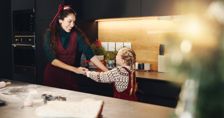 Christmas, dance and smile of mother with daughter in kitchen of home for baking or celebration....
