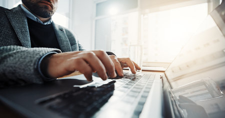 Typing, office and business man on laptop for finance report, online proposal and research. Professional, corporate and person on computer for planning, website or budget review for financial careerの写真素材