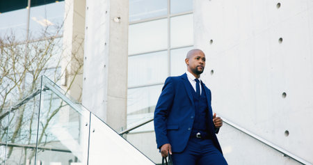 Trip, employee and man in city, stairs or rush to work in morning, commuting and attorney with case. Thinking, lawyer and black person in hurry for trial, serious and journey to court and reflectionの写真素材