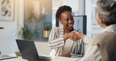 Handshake, partnership and smile with business people in office for agreement, deal or success. Collaboration, thank you and welcome with employee team shaking hands at work for bonus or promotionの写真素材