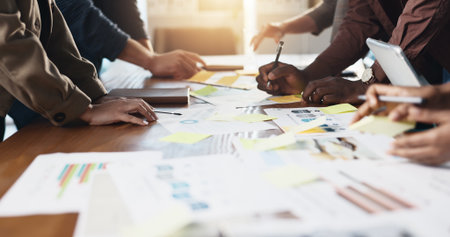 Collaboration, hands and infographic with business people in office boardroom for meeting or planning. Marketing, paper and strategy with employee team in workplace for chart, data or graph reviewの写真素材