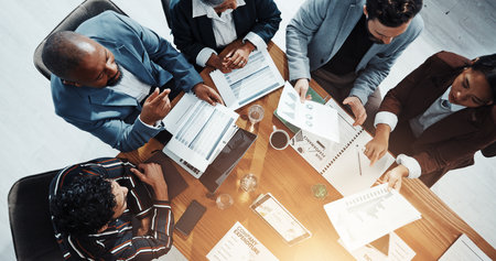 Documents, conversation and business people in office in collaboration for finance proposal from above. Paperwork, discussion and team of financial advisors with investment statistics for forecastingの写真素材