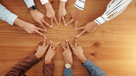 Business people, hands and top view of star with support, collaboration or team building. Above,...