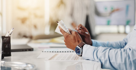 Hands, business and man in office, books and checklist for company audit, taxes and reading. Closeup, person and employee in workplace, financial advisor and report for investment and risk managementの写真素材