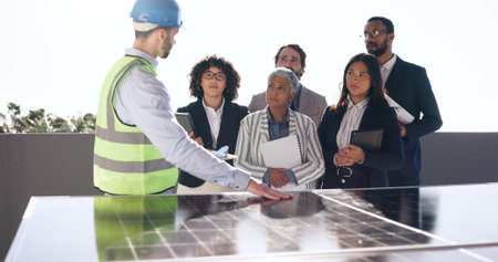 Presentation, solar panel and engineer with business people outdoor for photovoltaic, property and project. Technician prototype, realtor developer and group with power grid for renewable energy cellの写真素材