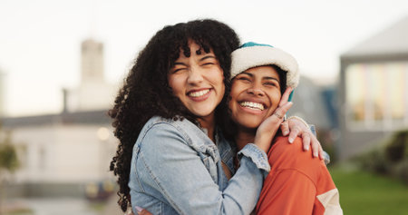 Happy, women and hug with friends in city for love, care and bonding together with affection. Smile, people and embrace for reunion, long distance friendship and support with connection in urban townの写真素材