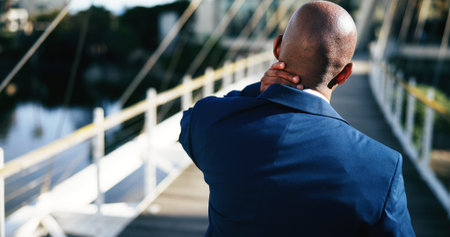 Neck pain, tired and back of business man in city for overworked, injury and property loss. Real...