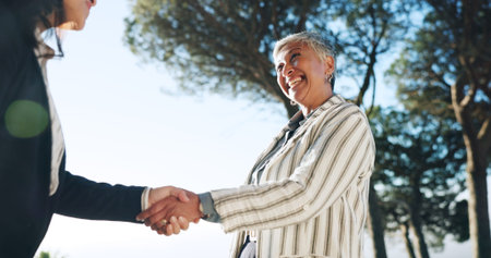 Deal, handshake and meeting with business people outdoor for bonus, goals or target from below....