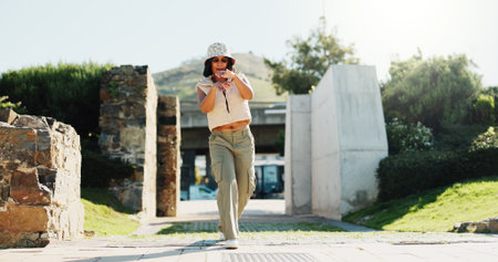 Dance, fashion and portrait of woman outdoor in summer for choreography, energy or expression. Attitude, music and rhythm with confident dancer person walking in park for excitement, fun or movementの写真素材