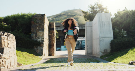 Attitude, dance and portrait of woman outdoor in summer for choreography, energy or expression. Fashion, music and rhythm with serious dancer person walking in park for excitement, fun or movementの写真素材