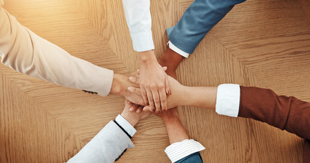 Above, desk and hands of business people in office for solidarity, cooperation and partnership....