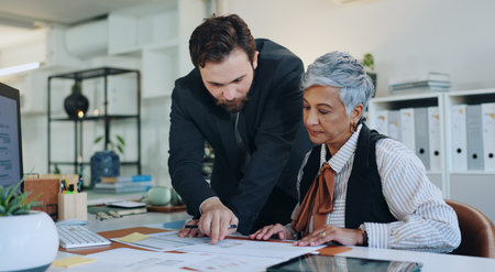 Man, woman and data analysis with documents at office, finance results, stats or team review at...