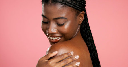 Skincare, woman and smile for smooth skin, self care and shine with cosmetics, wellness and healthy. Studio background, happy and black person with glow for bodycare, mockup space and dermatologyの写真素材