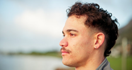 Serious, thinking and man for travel outdoor for vacation, weekend break and planning adventure. Space, male person and reflection for holiday ideas, tourist thoughts and nostalgia memory for getawayの写真素材