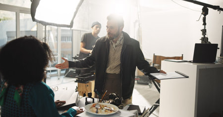 Upset, director and talking to actor, set and annoyed by mistake on take, entertainment or creative....