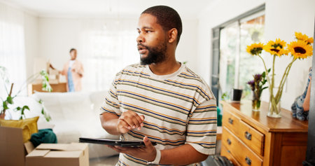 Thinking, tablet and moving with black man in new home for relocation, furniture inventory and real estate. Boxes checklist, property investment and reflection with couple in living room for planningの写真素材