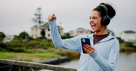 Success, fitness or excited woman in city with phone for workout, exercise goals or song. Lake,...