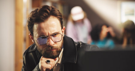 Planning, man and director in studio for editing with post production, process or casting online. Thinking, solution and filmmaker watching scenes for artistic project with shoot at creative agency.の写真素材