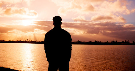Silhouette, man and back view with sunset at river for scenary, fresh air or outdoor journey. Male...