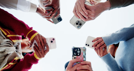 Phone, sky and social media with hands of friends outdoor in circle for connection from below. App,...
