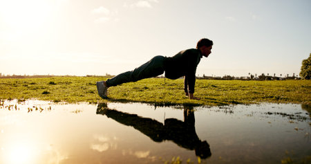Man, fitness and nature with push ups by lake for workout, arm exercise or physical activity....