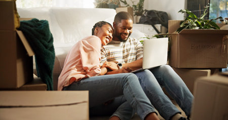 Happy, couple and browsing on laptop in new home, research or planning for renovation or discussion....