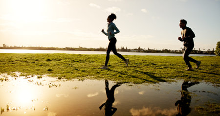 Fitness, running and sunset with couple outdoor at lake in nature for cardio training on space....