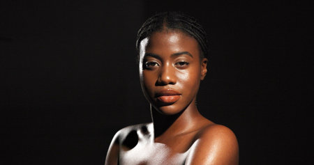 Beauty, glow and portrait with black woman in studio for skincare, smooth texture and dermatology. Hygiene, aesthetic and shine with person on dark background space for hydration and self careの写真素材