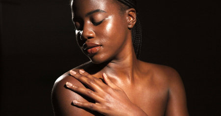 Skincare, beauty and black woman in studio for body care, satisfaction and spa wellness. Space, dark background and person with smooth skin, glow and shine for hydration, dermatology and cosmeticsの写真素材