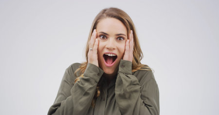 Portrait, woman and shocked expression in studio for announcement, good news and hearing secret....