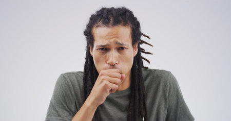 Cough, sick and portrait of man in studio with chest infection, respiratory disease and illness. Mockup space, health and isolated person with pneumonia, flu and asthma symptoms on white backgroundの写真素材