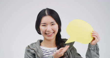Portrait, speech bubble and Asian woman in studio, smile and social media on white background....