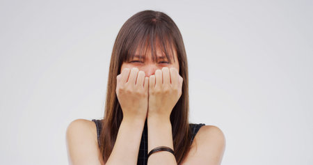 Portrait, crying and woman in studio, sad and depression with emotion on white background. Asian...