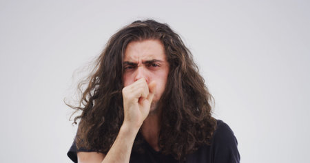Man, coughing and sick in studio with health, lung infection or bacteria from medical condition....