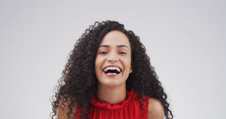 Portrait, smile and woman laughing in studio with expression, funny joke and reaction to meme. Happy, female person and humor for positive attitude, good vibes and silly emotions on white backgroundの写真素材