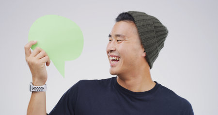 Man, speech bubble and excited mockup for communication, marketing or chat in studio. Approval, smile and person with space for opinion isolated on white background for promotion, feedback or quoteの写真素材