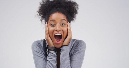 Excited woman, portrait or surprise with emotion for winning in studio on a white background. Happy,...