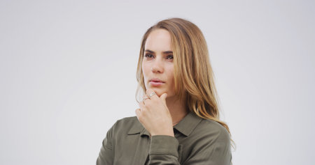Ideas, planning and thinking with woman on studio space for brainstorming, contemplation or wonder. Choice, decision and why with face of person isolated on white background for thought or visionの写真素材