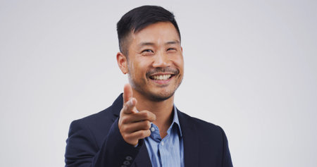 Happy businessman, finger gun and studio for point at you in portrait, sign or choice on white...