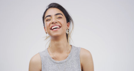 Laughing, happy and portrait of woman in studio with mockup space for comedy joke with humor. Goofy, smile and female person from Brazil with giggle for funny, gossip or comic by white background.の写真素材