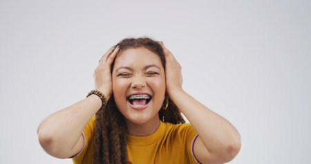Shock, excited and scream with woman in studio for winner, scholarship or deans list announcement. Surprise, academic merit and student reward with person on white background for wow, space and bonusの写真素材