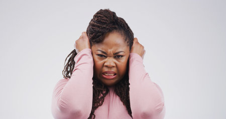 Angry, frustrated and portrait of black woman in studio with reaction, emotional and upset for bad news. Mockup space, white background and isolated person stressed out for mistake, crisis and angerの写真素材