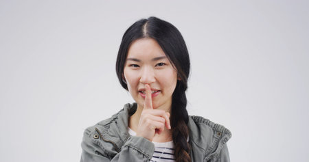 Happy, portrait and woman in studio with secret, gossip or confidential hand gesture for privacy....